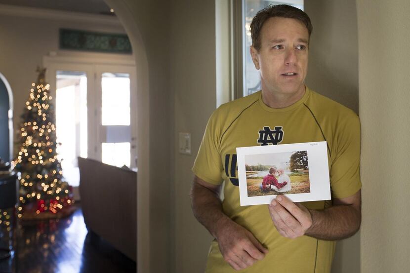 
Patrick Fallon holds a photograph of a young cancer patient he is running to honor. Jonny ...