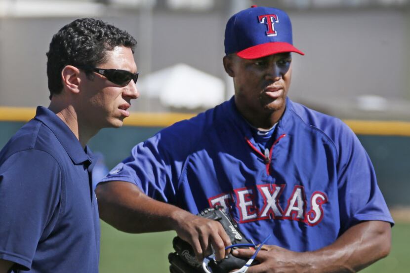 Texas general manager Jon Daniels talks with third baseman Adrian Beltre before the...