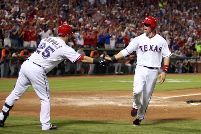Texas Rangers catcher Mike Napoli (25) congratulates Texas Rangers designated hitter Michael...
