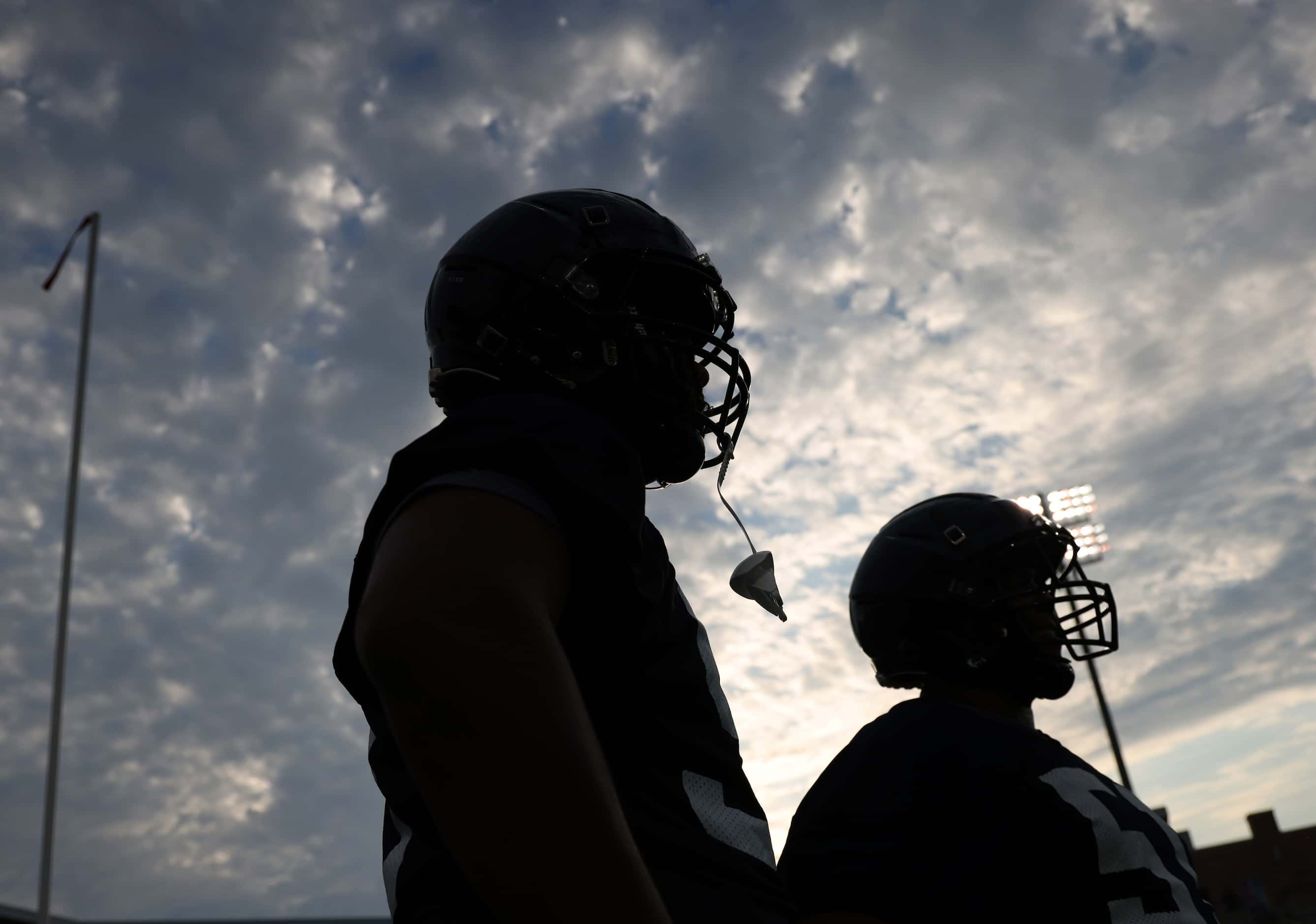 Allen Eagles defensive linemen Michael Jackson-Jones, left, and Quentin Carter look on as...