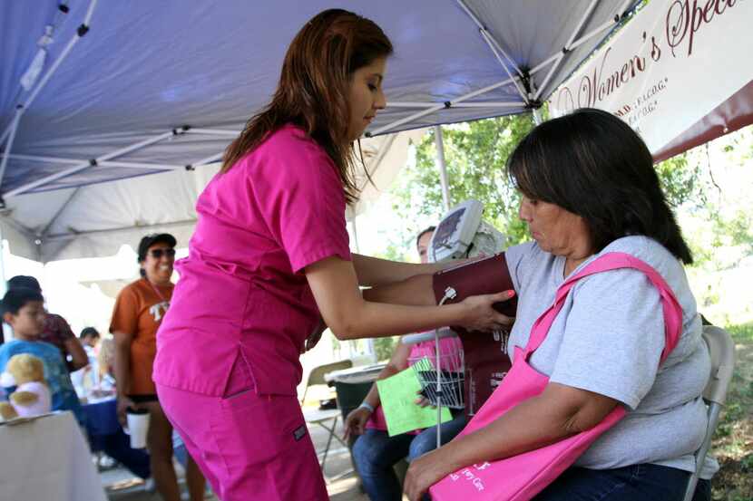 Medical assistant Cindy Banda of the Women's Speciality Center tests the blood pressure of...