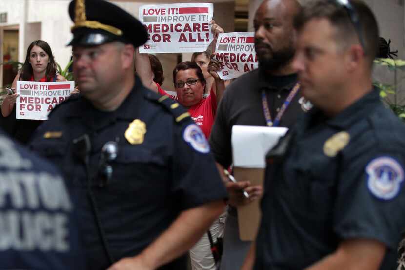 WASHINGTON, DC - JULY 19:  Activists hold signs in a protest against the Republican health...