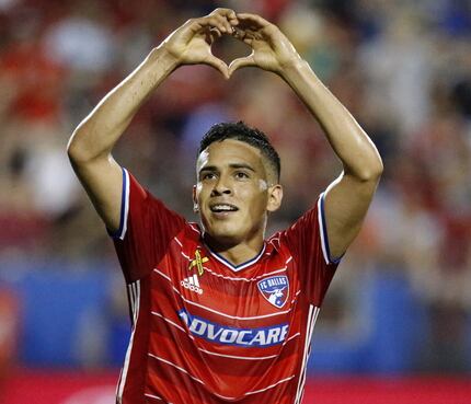FC Dallas midfielder Victor Ulloa (8) flashes a heart shape with his hands to the fans after...