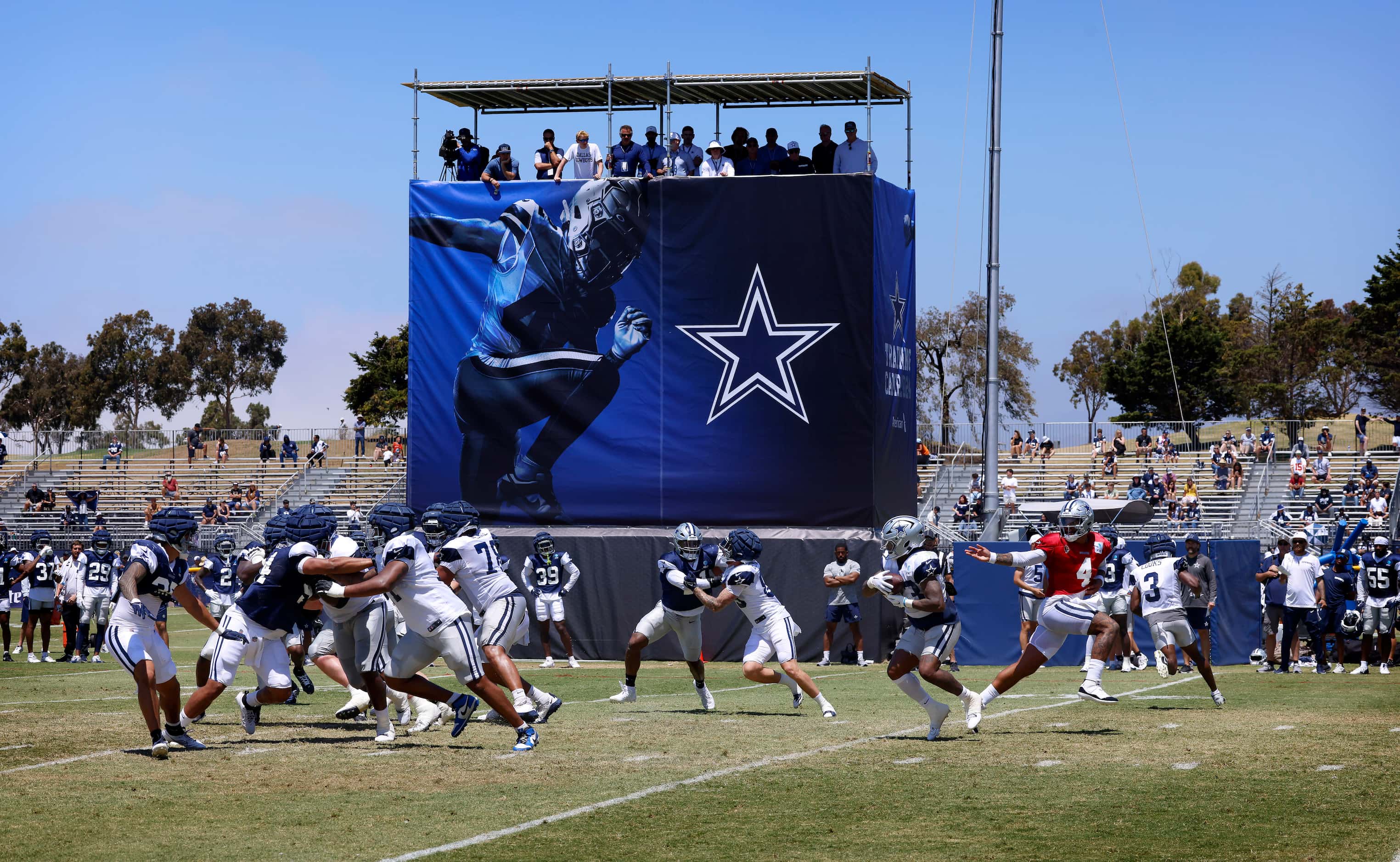 Dallas Cowboys quarterback Dak Prescott (4) hands the ball off to running back Rico Dowdle...