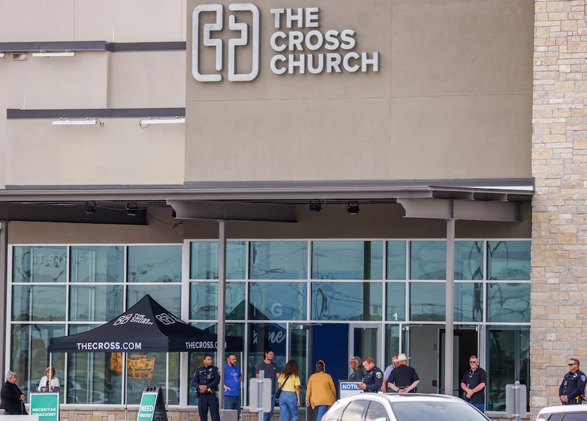 People enter the doors of The Cross Church in Wylie for a community vigil in honor of...