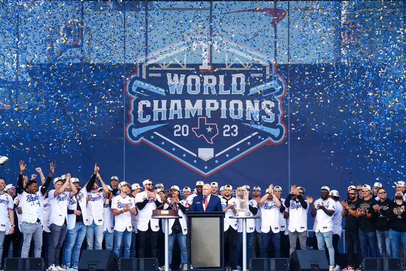 Confetti flies during the last half of Texas Rangers post-parade public celebration lead by...