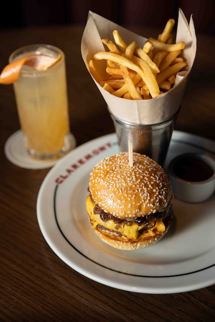 The Claremont Burger is made with American cheese and caramelized onions. It's photographed...