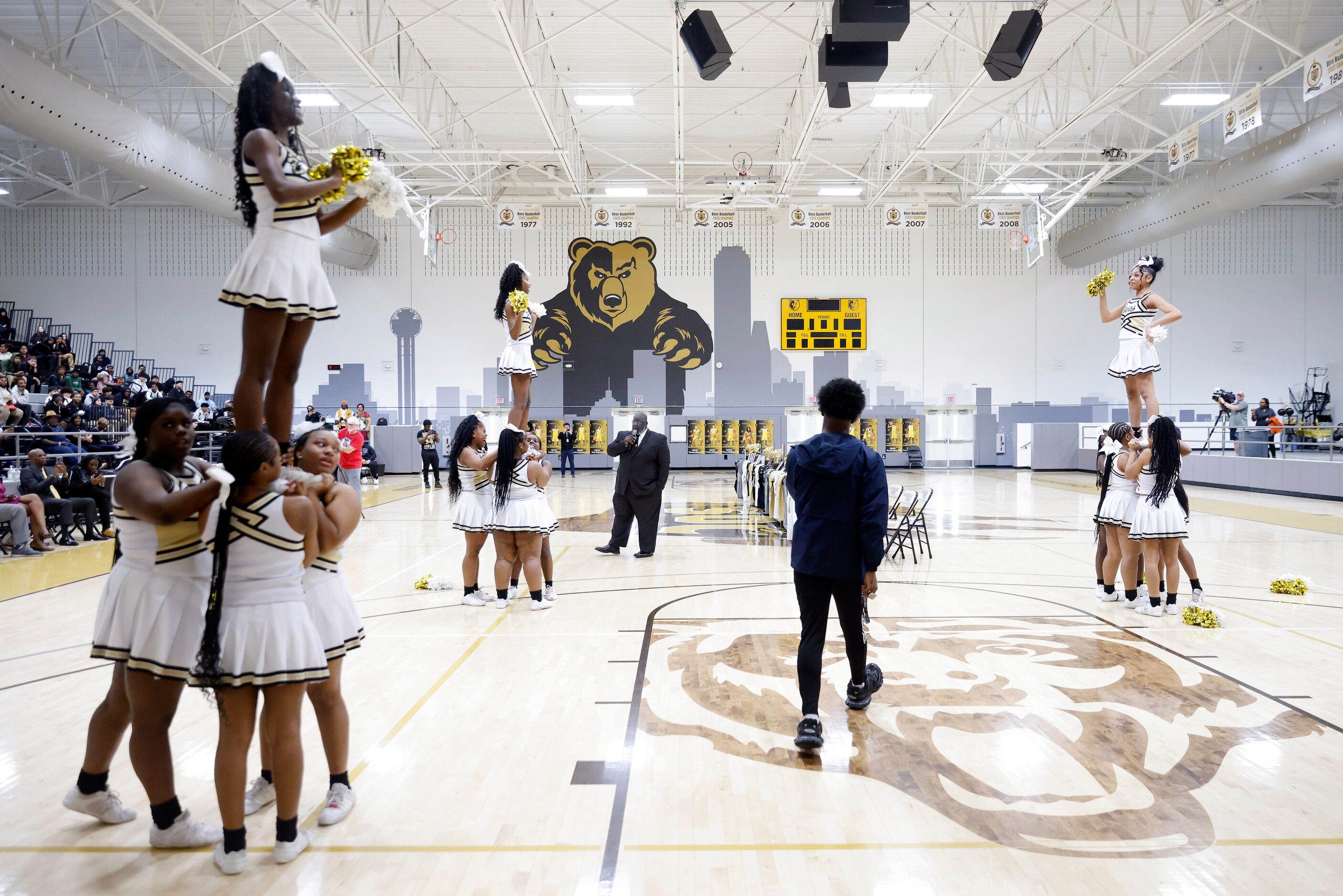 South Oak Cliff football player Brandon Jones walks between the cheerleaders as he’s...