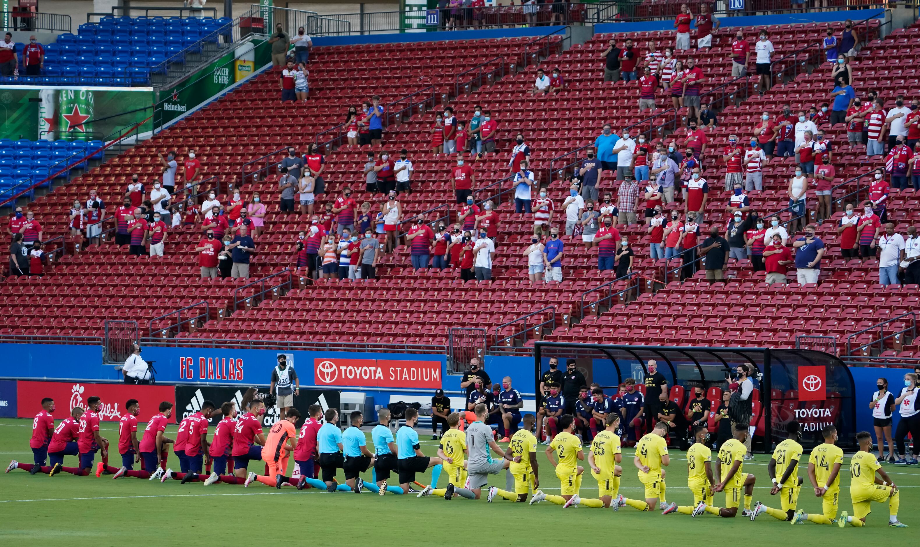 FC Dallas (left) and Nashville SC players kneel during the national anthem before an MLS...