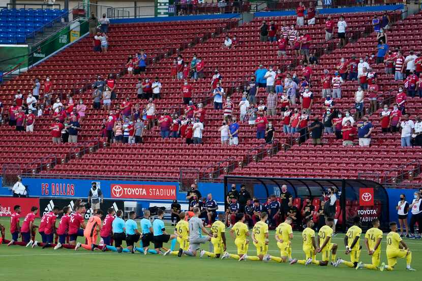 FC Dallas (left) and Nashville SC players kneel during the national anthem before an MLS...