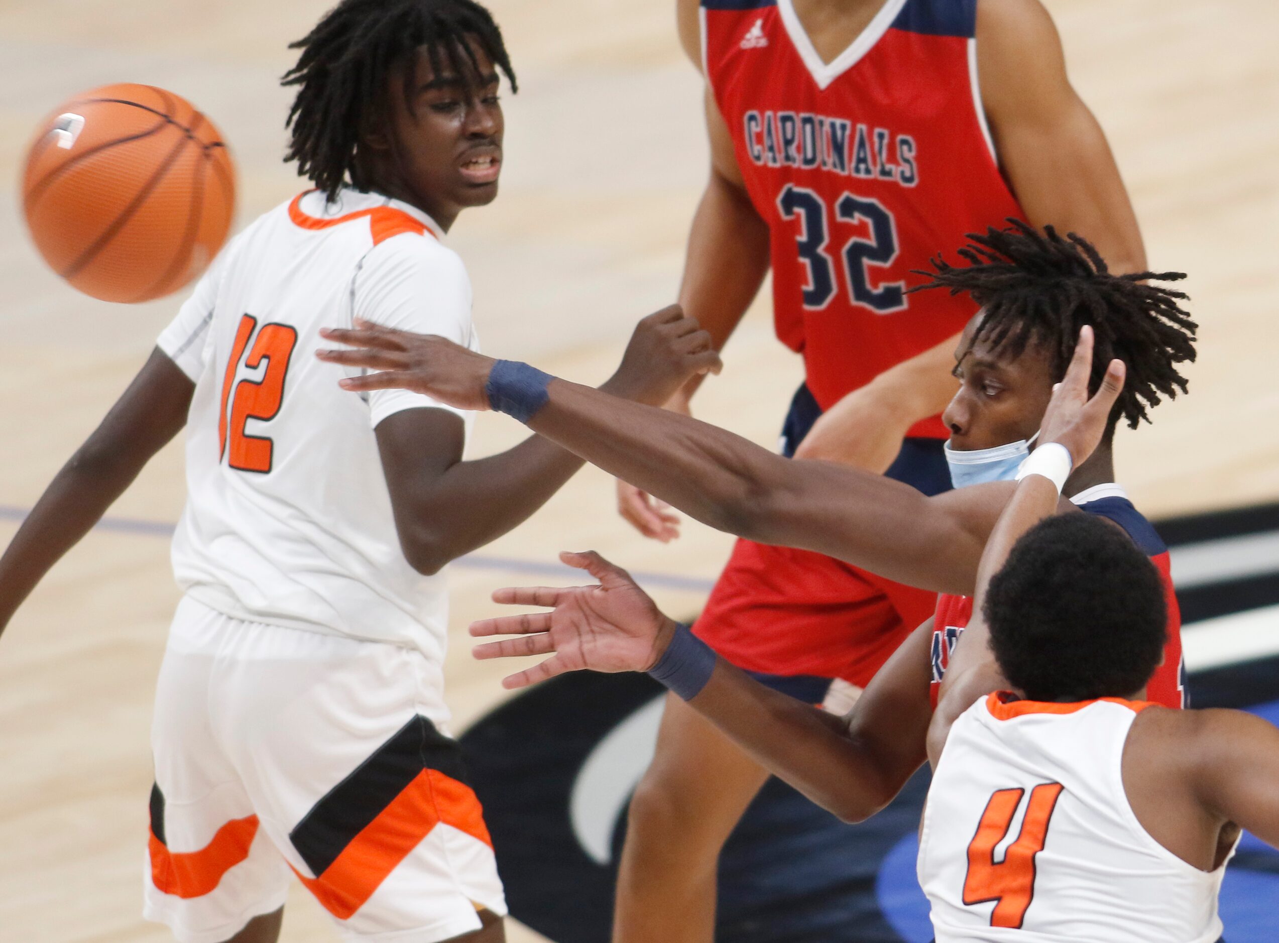 Plano John Paul ll senior Manny Obaseki (13) passes between the defense of Lancaster's JaRod...