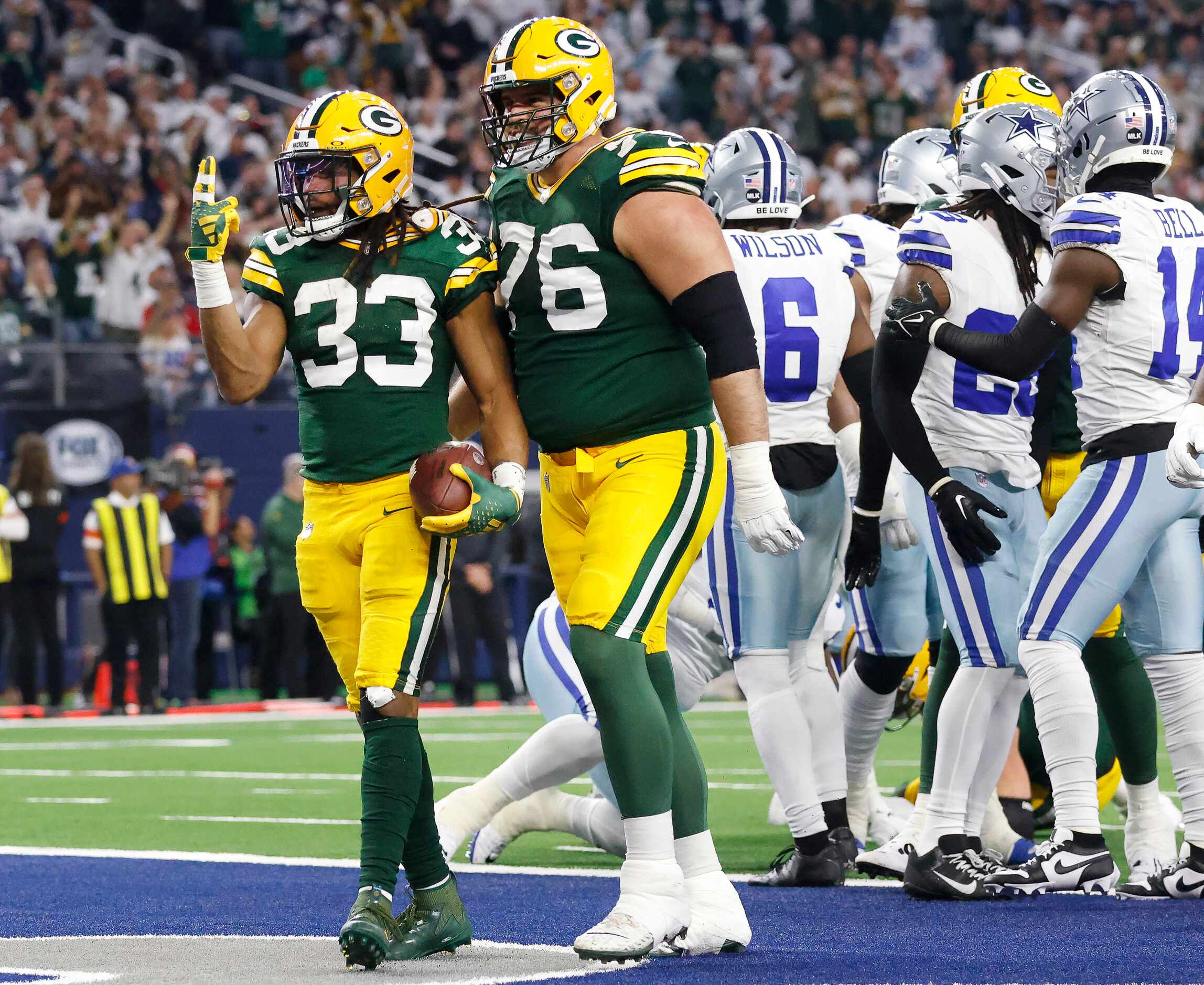 Green Bay Packers running back Aaron Jones (33) celebrates his second quarter touchdown with...