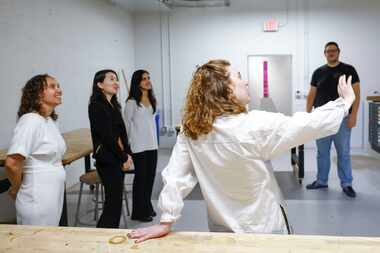 Cat Rigdon (front) of Cedars Union gives a tour of the organization to Dallas Morning News...