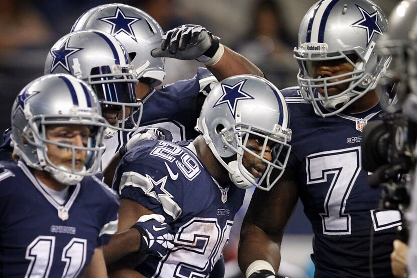 Dallas Cowboys running back DeMarco Murray (29) is congratulated by teammates after scoring...