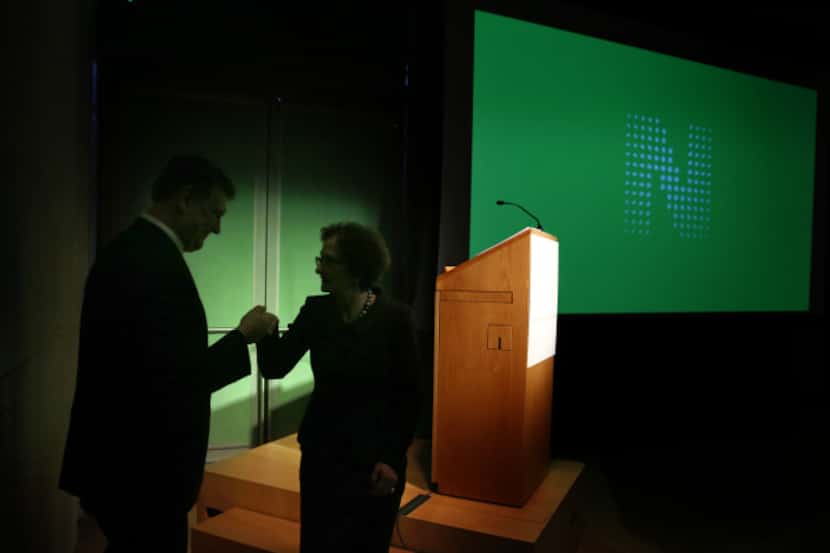 Nasher Sculpture Center trustee Nancy Nasher Haemisegger is helped from the podium by Dallas...