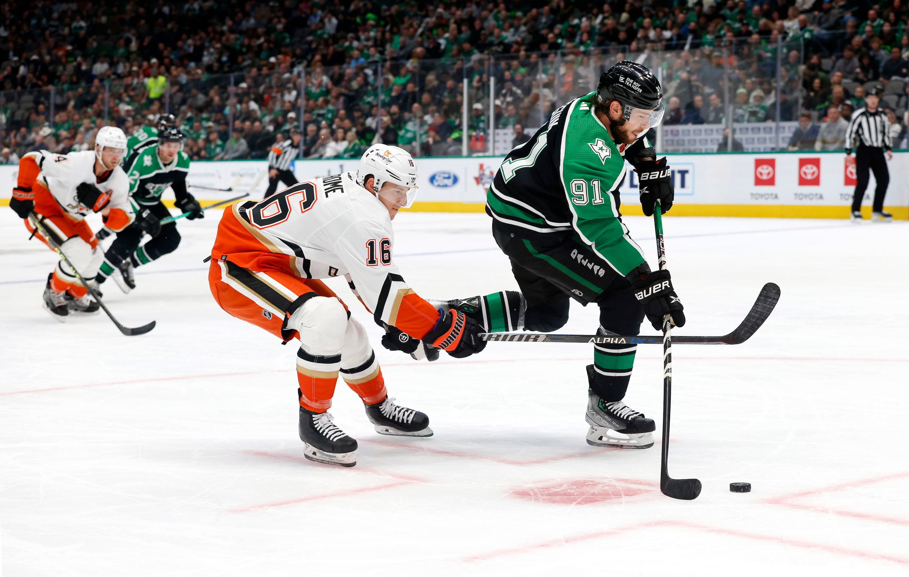 Dallas Stars center Tyler Seguin (91) takes a shot as he’s pursued by Anaheim Ducks center...