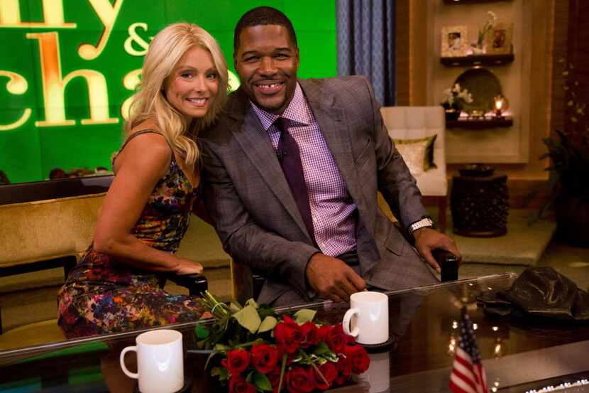 Michael Strahan, right, poses Kelly Ripa on the set of the newly named "Live! with Kelly and...