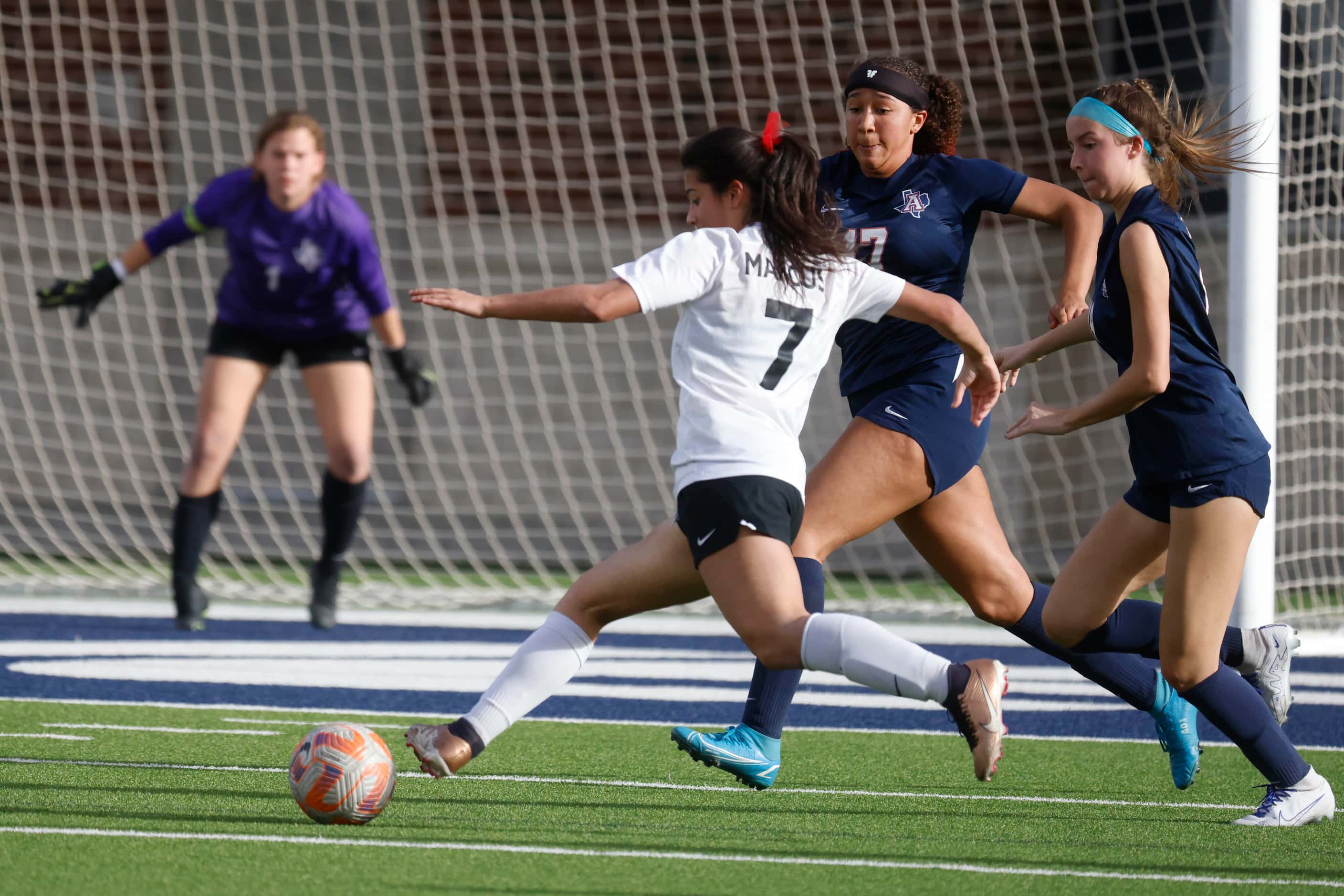 Marcus’ Bella Campos shoots the ball for a goal against Allen high during the first half of...