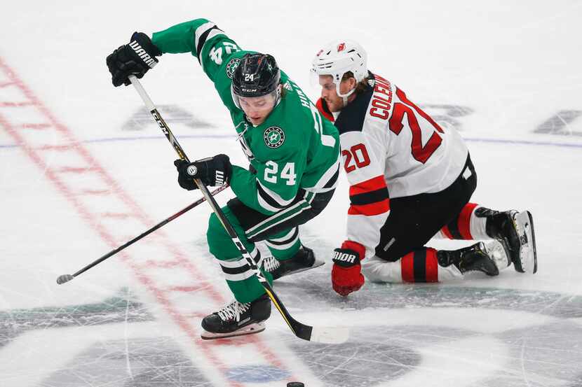 FILE - Stars left wing Roope Hintz (24) steals the puck from New Jersey Devils center Blake...