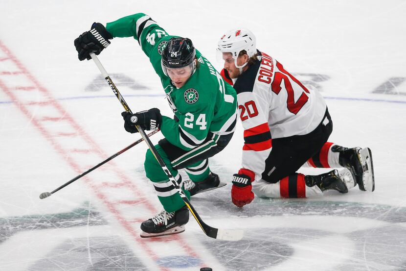 Dallas Stars left wing Roope Hintz (24) steals control from New Jersey Devils center Blake...