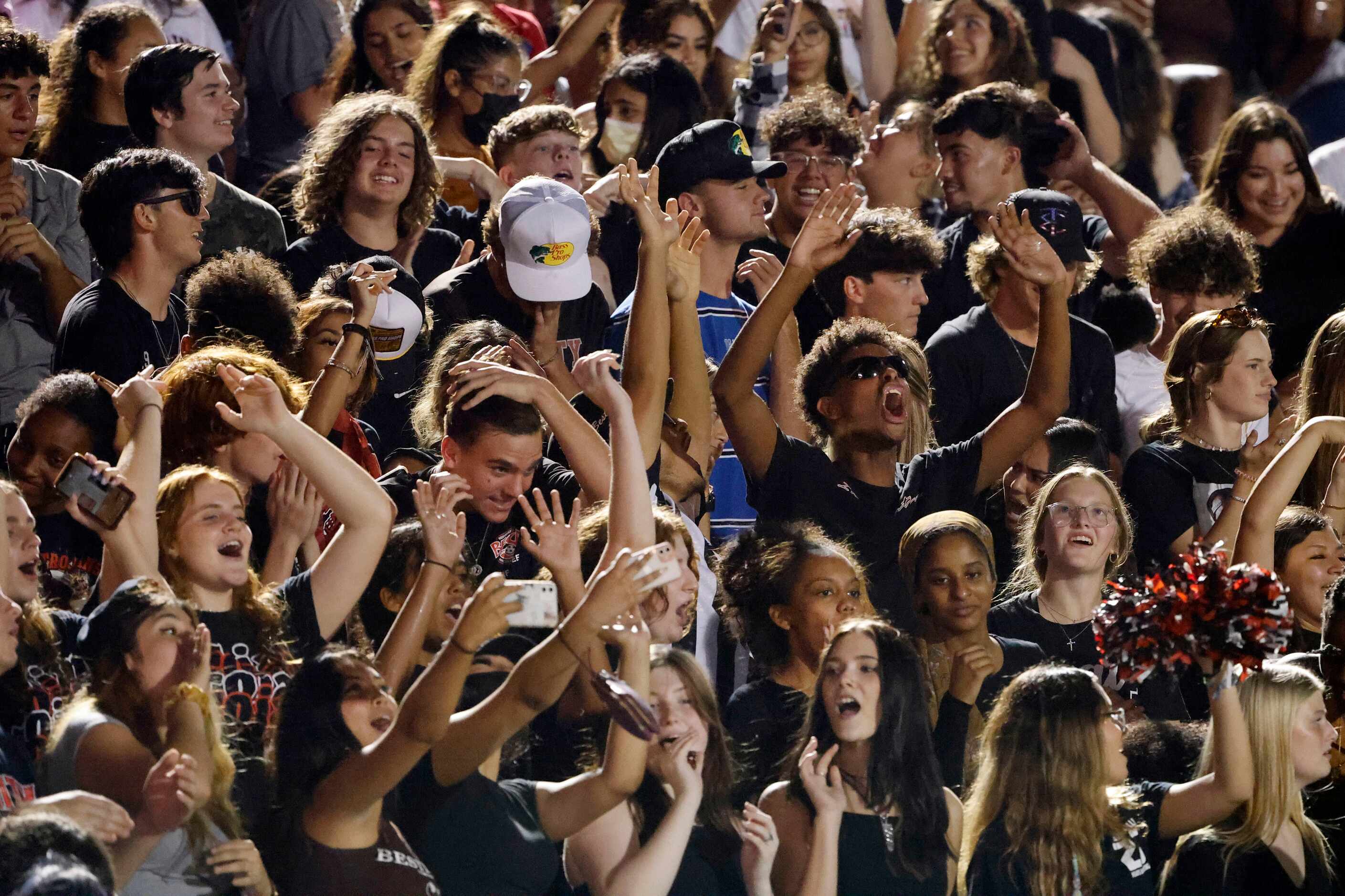 The Euless Trinity student section cheers during the first half of their high school...