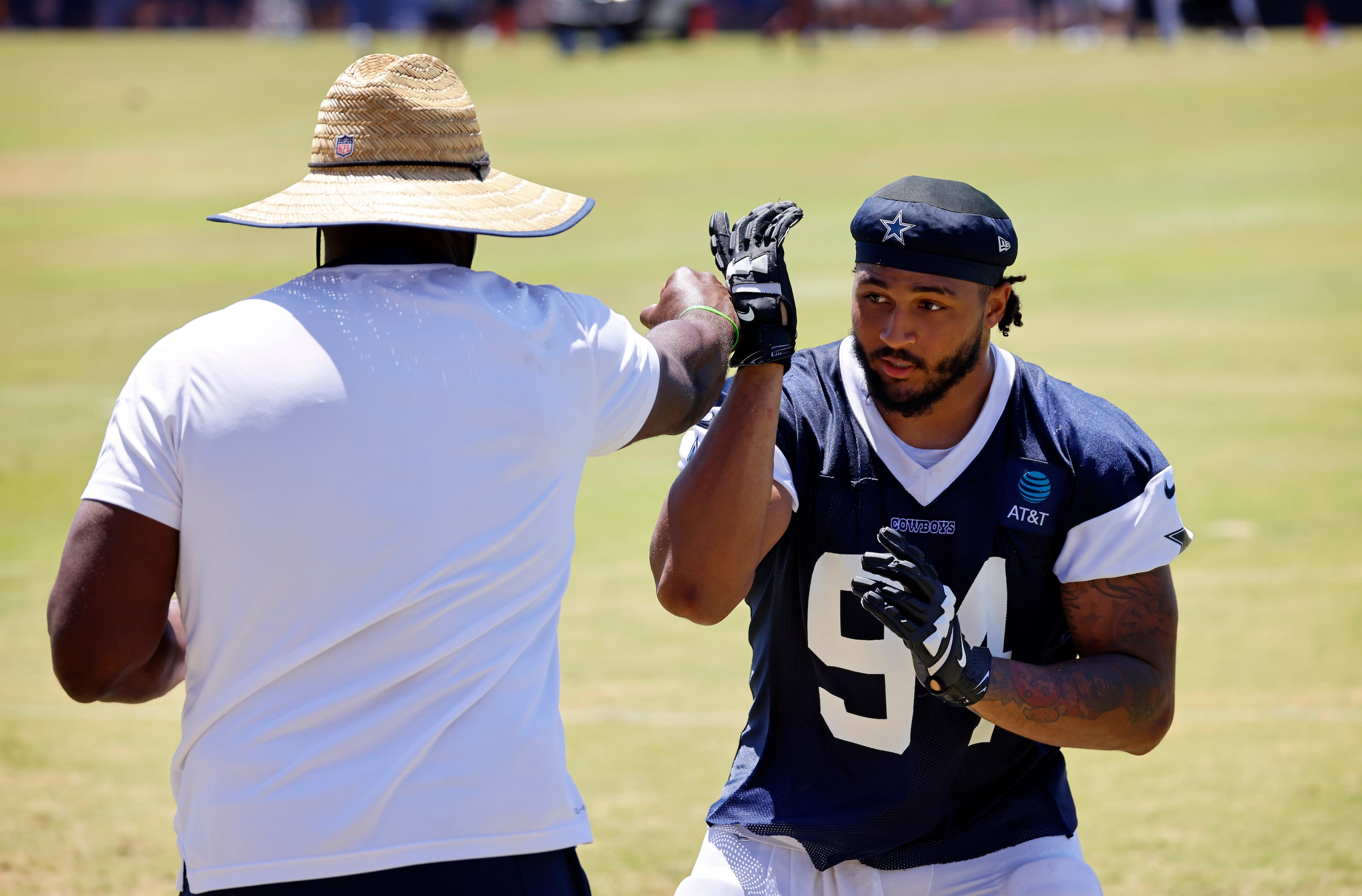 Dallas Cowboys defensive end Marshawn Kneeland (94) works on his pass rushing skills...