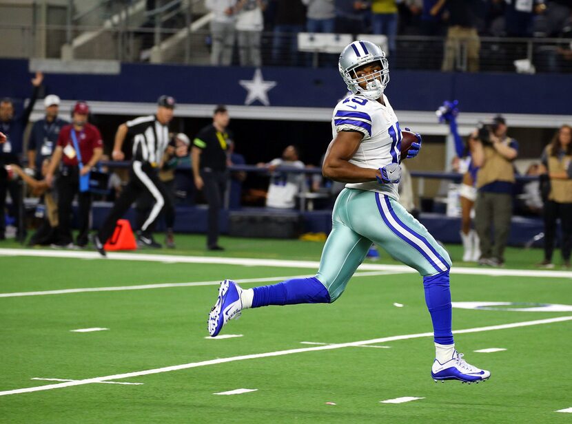 ARLINGTON, TEXAS - DECEMBER 09: Amari Cooper #19 of the Dallas Cowboys looks behind him as...