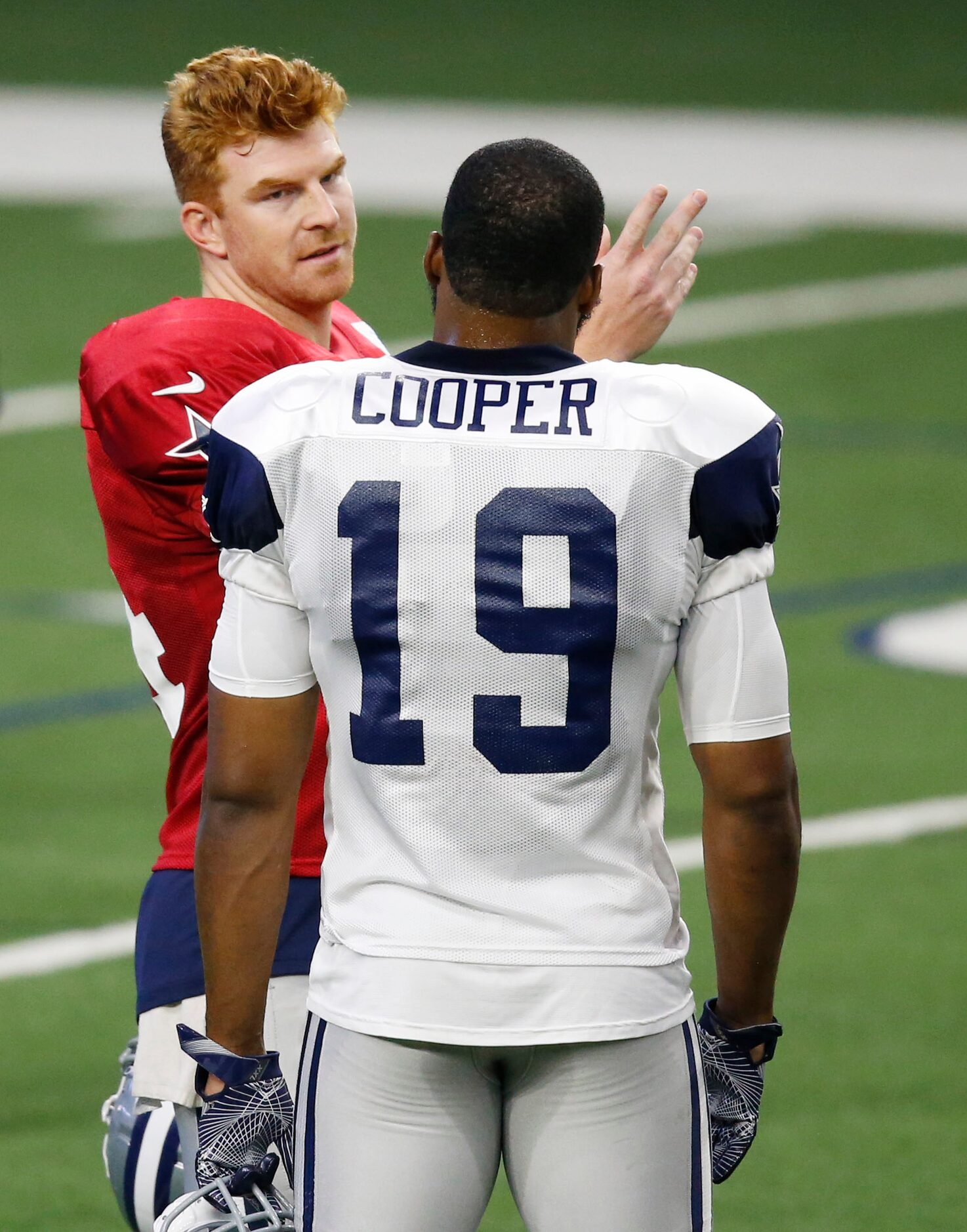 Dallas Cowboys quarterback Andy Dalton (14) talks to Dallas Cowboys wide receiver Amari...