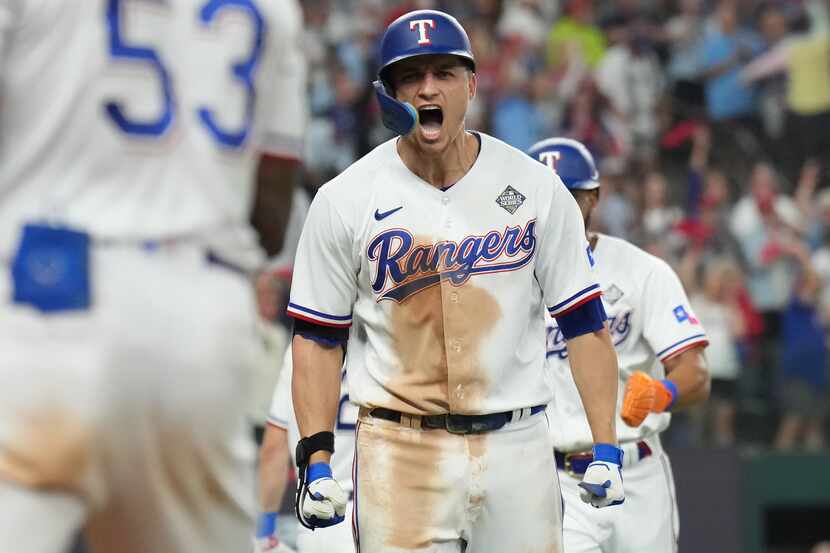 Texas Rangers' Corey Seager celebrates after hitting a two-run home run to tie the game...
