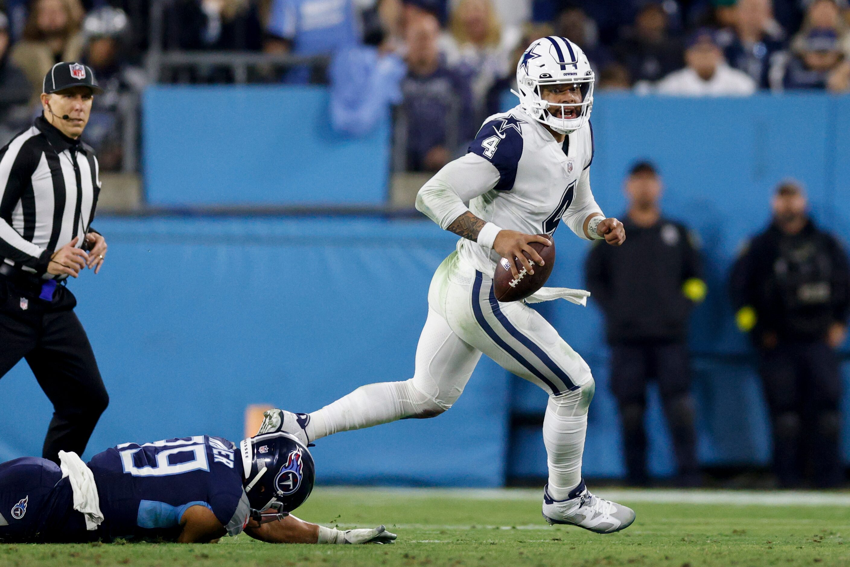 Dallas Cowboys quarterback Dak Prescott (4) evades pressure from Tennessee Titans linebacker...