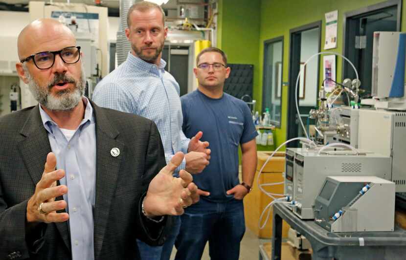 University of North Texas chemistry professor Guido Verbeck (left) talks about a...