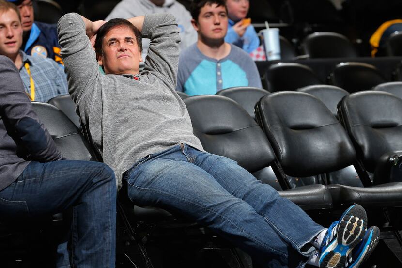 DENVER, CO - JANUARY 14: Mark Cuban, owner of the Dallas Mavericks, sits courtside as his...