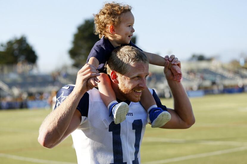 Dallas Cowboys wide receiver Cole Beasley (11) gives his son Ace a ride on his shoulders...