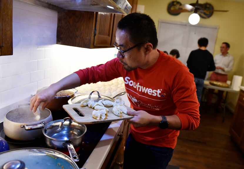 Lin Wang places vegetarian dumplings into boiling water during a Chinese New Year party in...