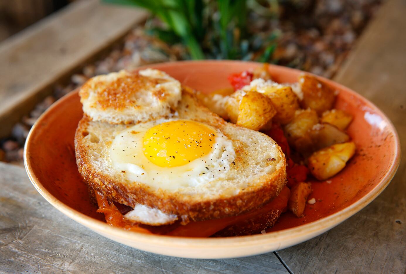 Egg in a Hole on sourdough is served with breakfast potatoes at Press Cafe restaurant at The...