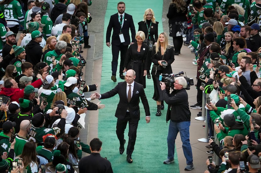Former Dallas Stars player Sergei Zubov fist bumps fans as he arrives for his jersey...
