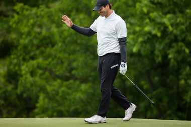 Tony Romo waves to fans on the 9th green during round 2 of the Bryon Nelson golf tournament...