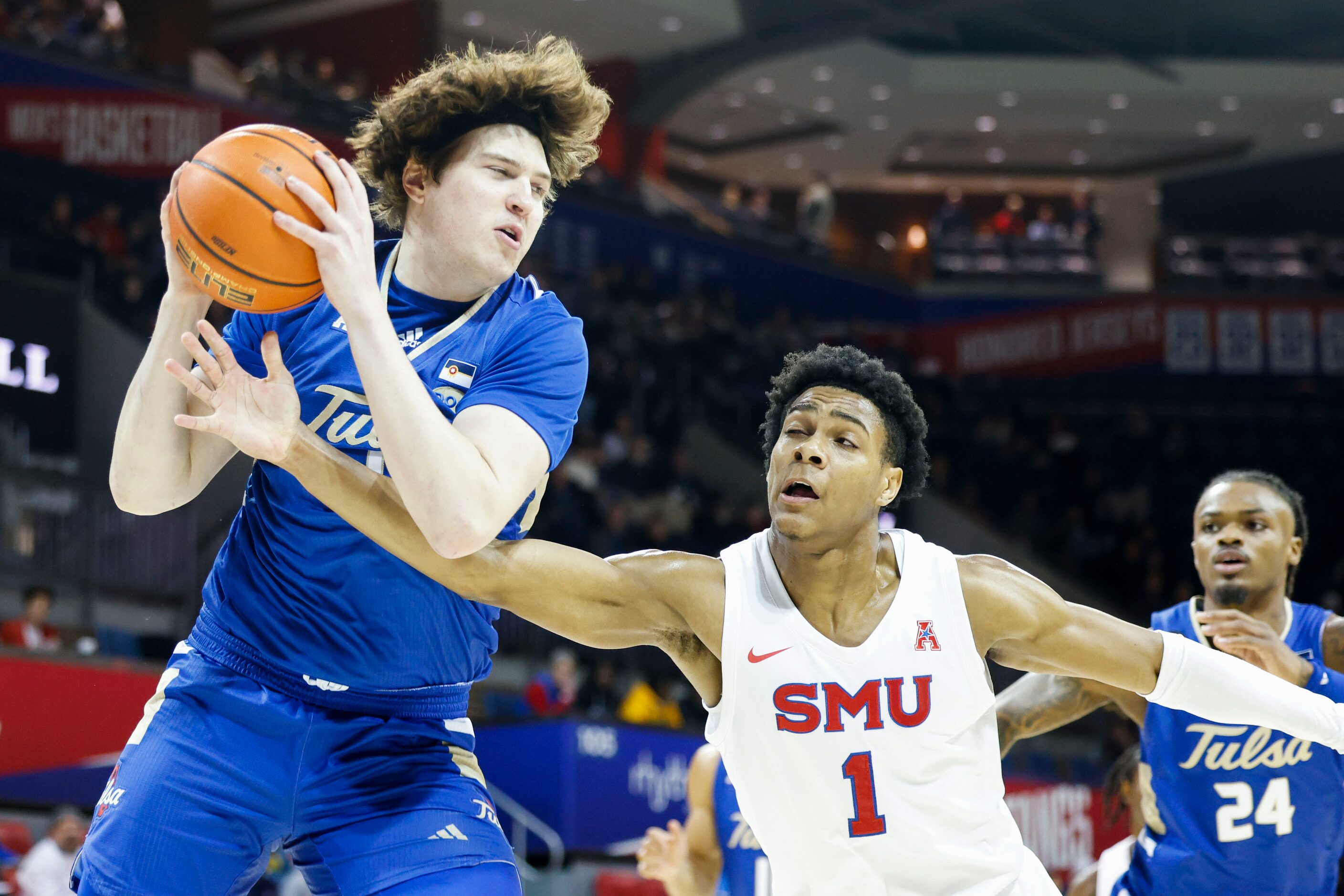 Tulsa forward Matt Reed (left) takes the ball away from Southern Methodist guard Zhuric...