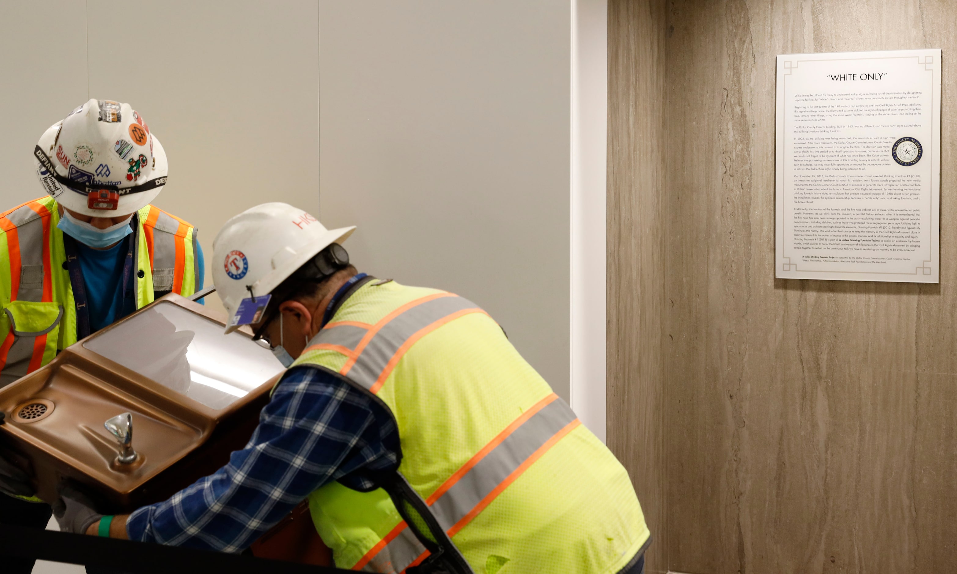 Saul Fuentes and Mario Vilatoro fit a segregation-era water fountain before it is sent for...