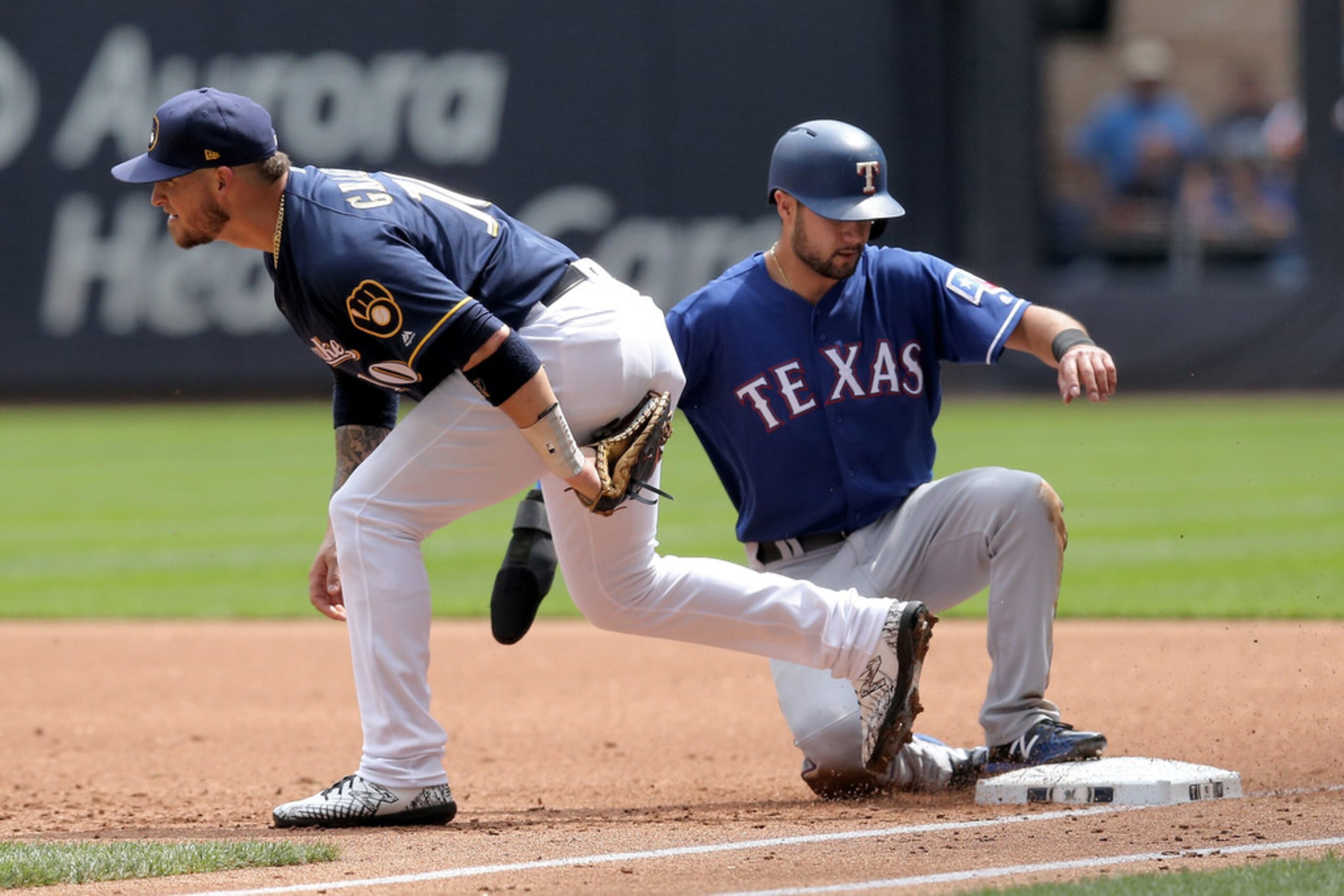 MILWAUKEE, WISCONSIN - AUGUST 11:  Yasmani Grandal #10 of the Milwaukee Brewers doubles up...