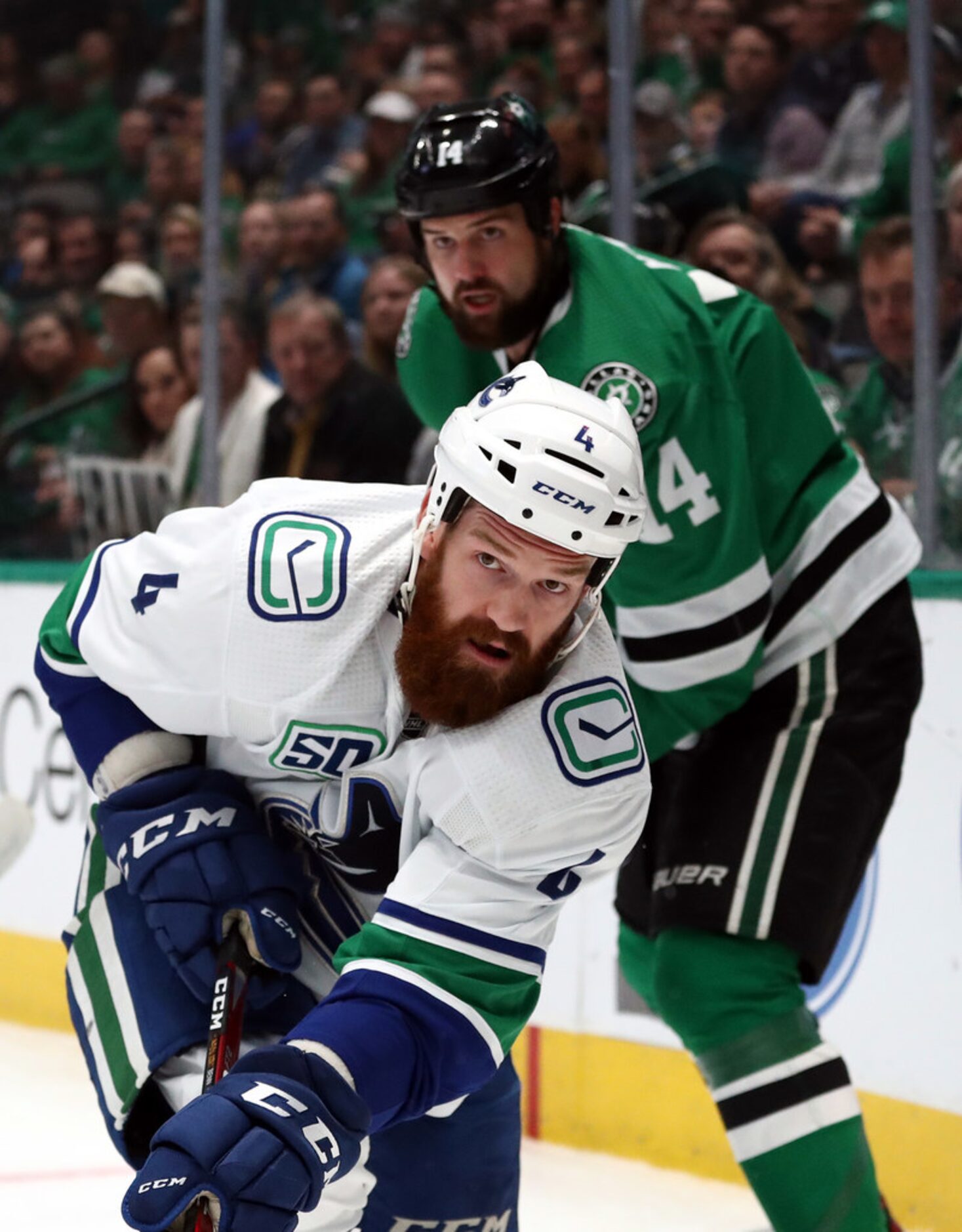 DALLAS, TEXAS - NOVEMBER 19:  Jordie Benn #4 of the Vancouver Canucks skates the puck...