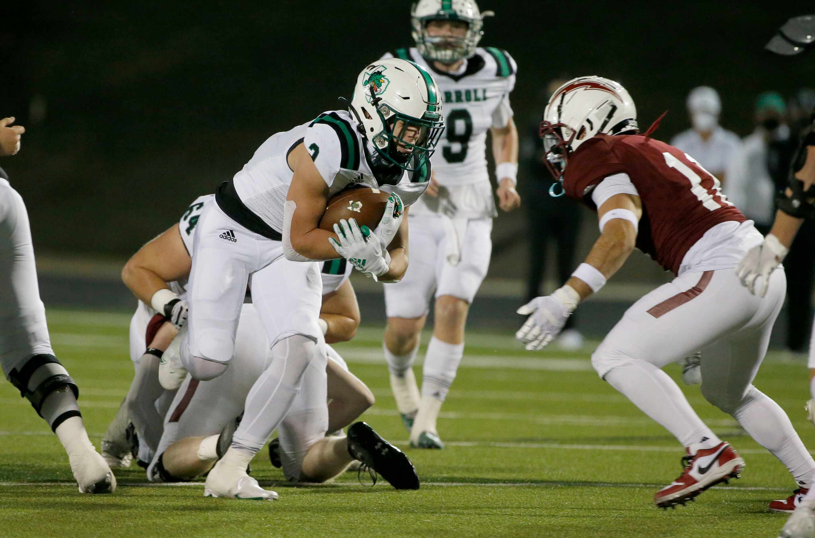 Southlake running back Owen Allen (2) runs for yardage as he is defended by Keller Central’s...
