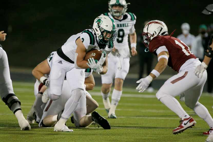 Southlake running back Owen Allen (2) runs for yardage as he is defended by Keller Central’s...