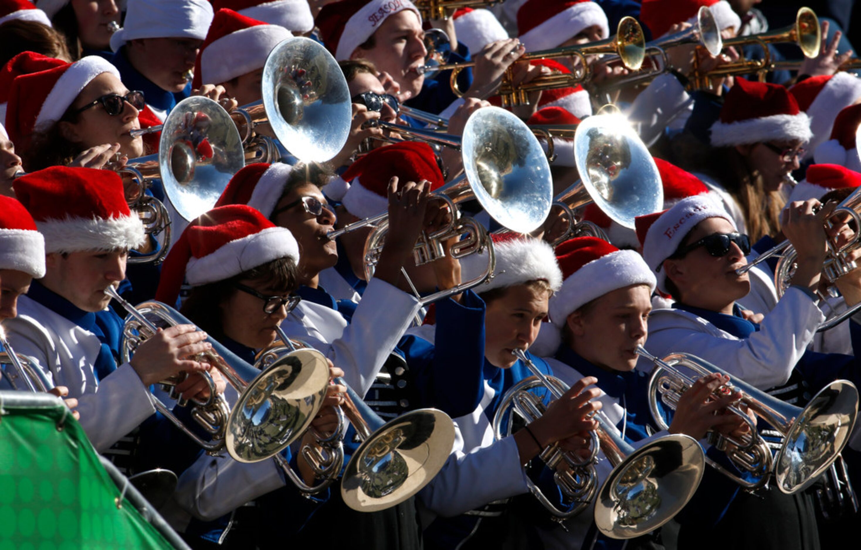 Members of the Allen Eagles band's brass section perform from the stands during the first...