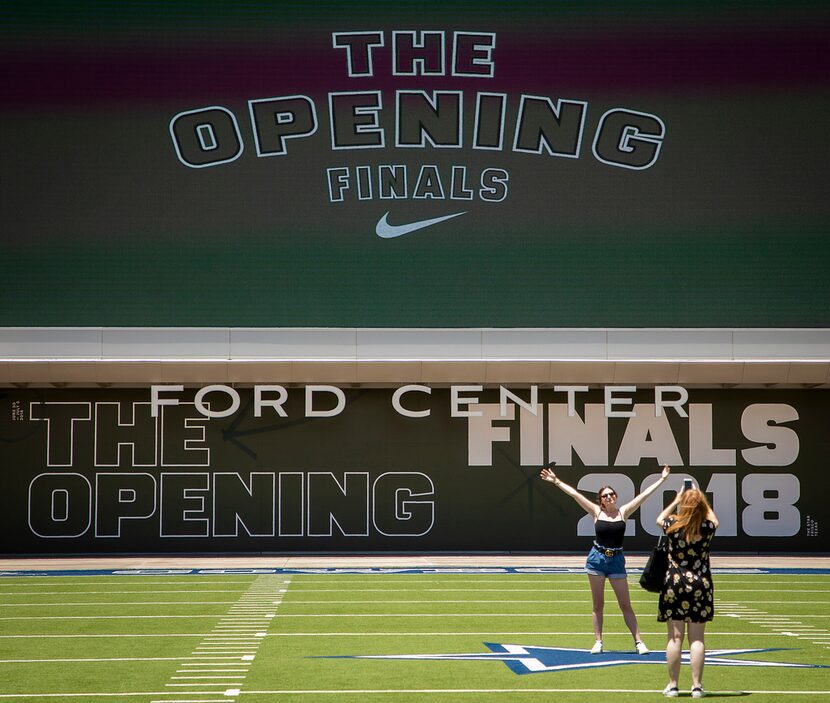 Spectators pose for photos outside the venue during the third day of The Opening at The Star...