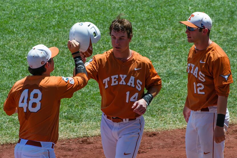 Jun 20, 2014; Omaha, NE, USA; Texas Longhorns outfielder Ben Johnson (14) greets teammates...