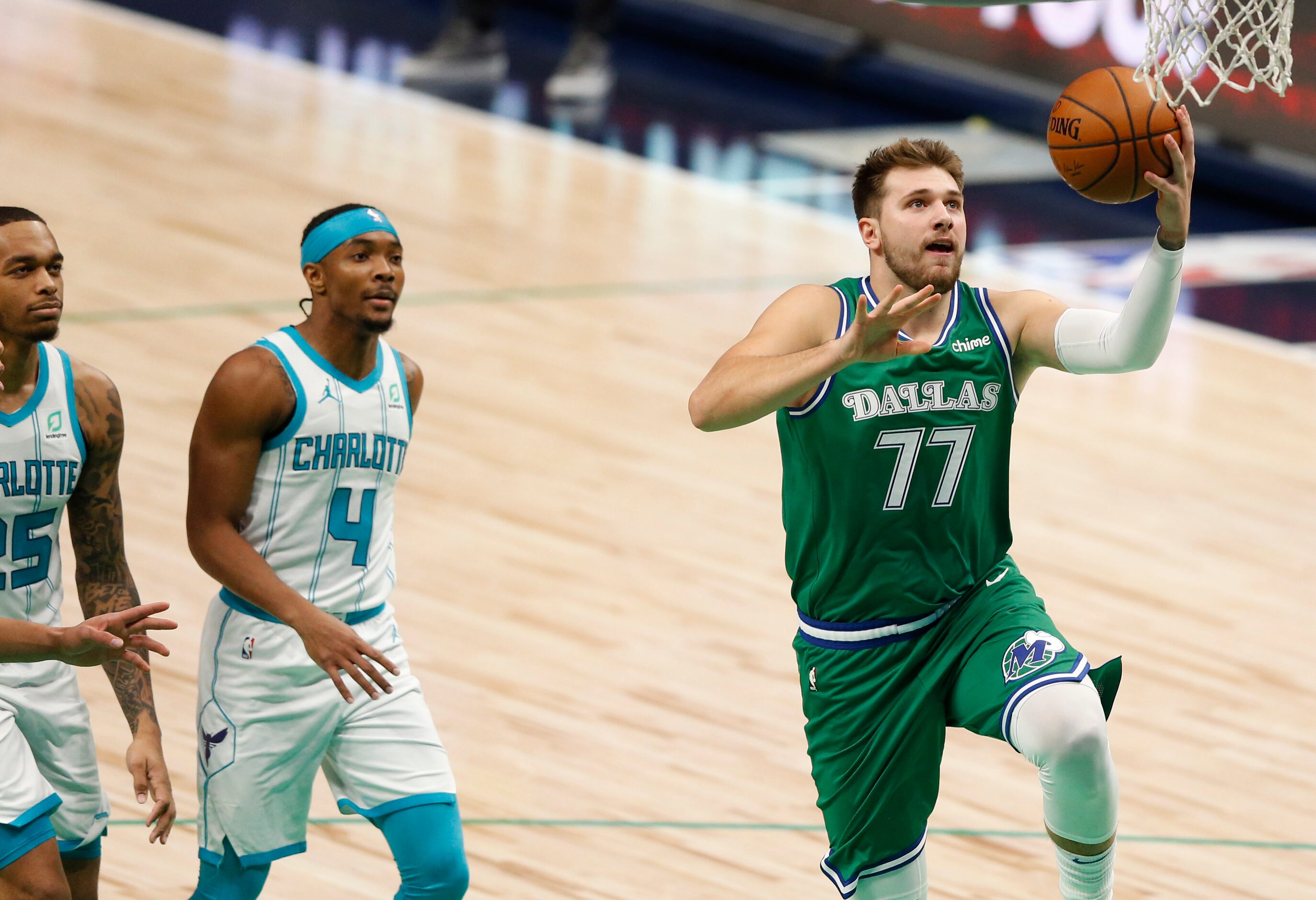 Dallas Mavericks guard Luka Doncic (77) attempts a layup in a game against the Charlotte...