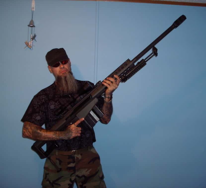 Steven "Stainless" Cooke, a general in the Aryan Brotherhood of Texas, holds a Barrett .50...