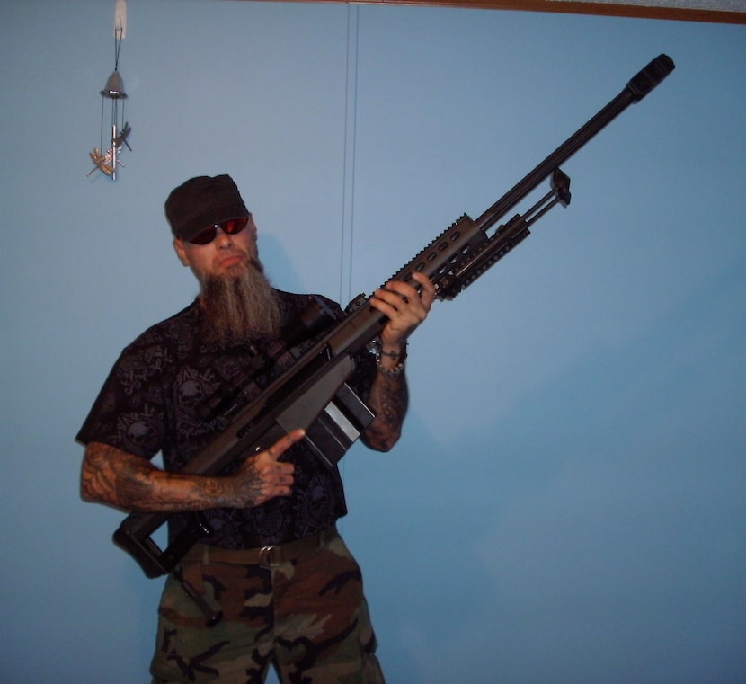 Steven "Stainless" Cooke, a general in the Aryan Brotherhood of Texas, holds a Barrett .50...