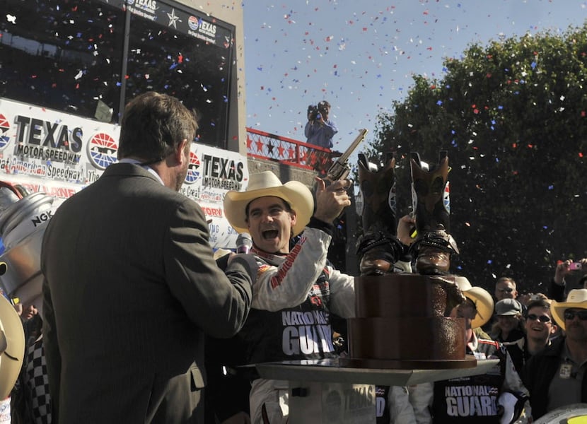 Jeff Gordon celebrates by shooting the Texas Motor Speedway Beretta Victory Lane Stampedes...
